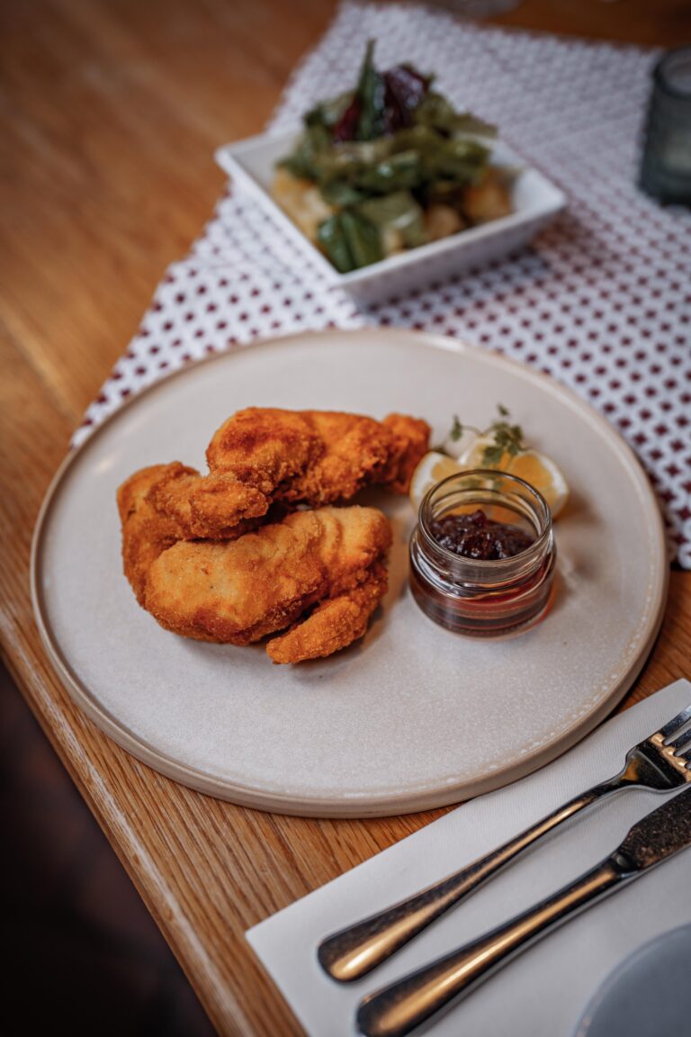 knuspriges, goldgebräuntes Backhendl mit Erdäpfelrucola Salat